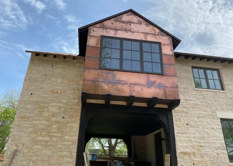 Copper metal panel facade on a stone building for Roof Repair in West Manheim